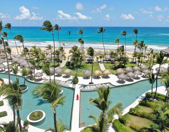 Excellence Punta Cana adults-only all-inclusive resort with tropical landscaping and oceanfront pools.