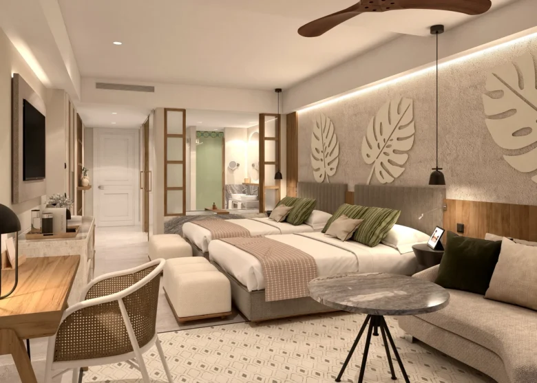Junior Suite Partial Ocean View with two double beds and seating area at Secrets Playa Esmeralda Resort & Spa.