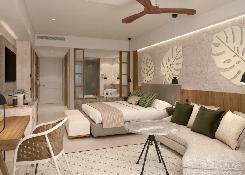 Junior Suite Swim Out living area with sofa and seating at Secrets Playa Esmeralda Resort & Spa.